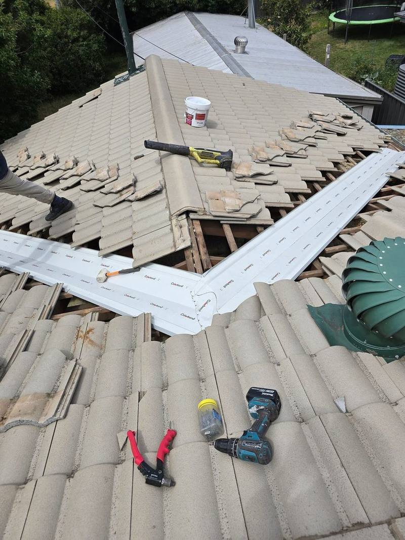 Tiles lifted, battens and sarking exposed